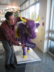 Mark Hosler of Negativland posing with the purple Yahoo! cow statue