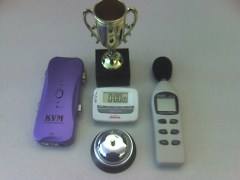Tools for Yahoo! Hack Day: a trophy, a KVM switch, a countdown timer, a sound-level meter and a desk bell