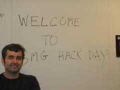Me in front of a whiteboard reading Welcome to SMG Hack Day, at the first Hack Day at Yahoo!